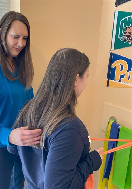 Physical therapist helping a patient increase upper body strength