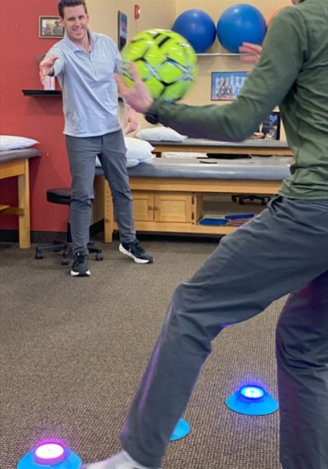 Physical therapist assisting patient with coordination exercises