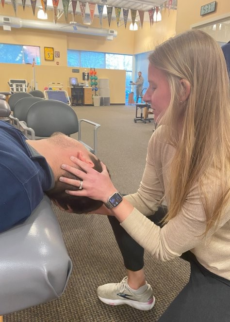 A physical therapist helps a patient with neck and spine issues