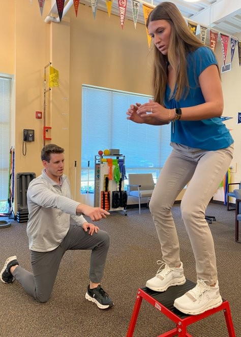 A patient works with a physical therapist